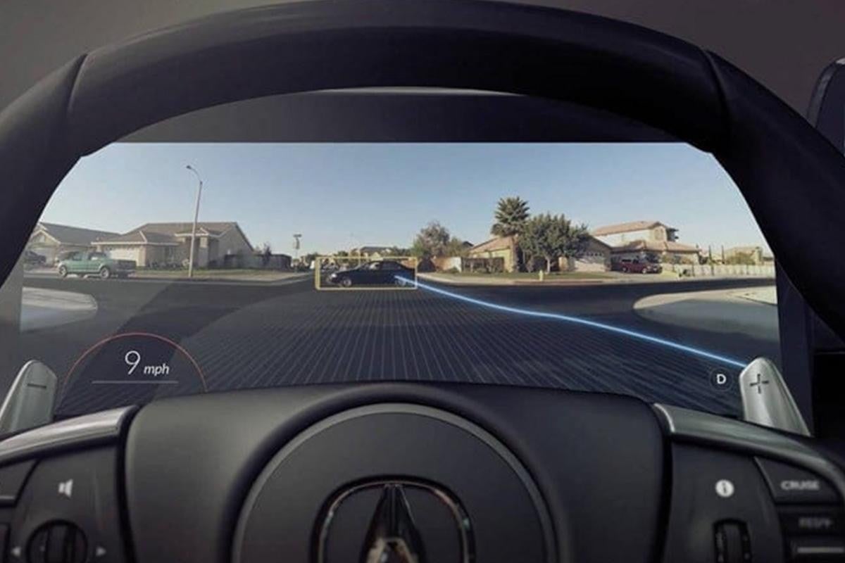 Car dashboard showing augmented reality navigation on windshield display