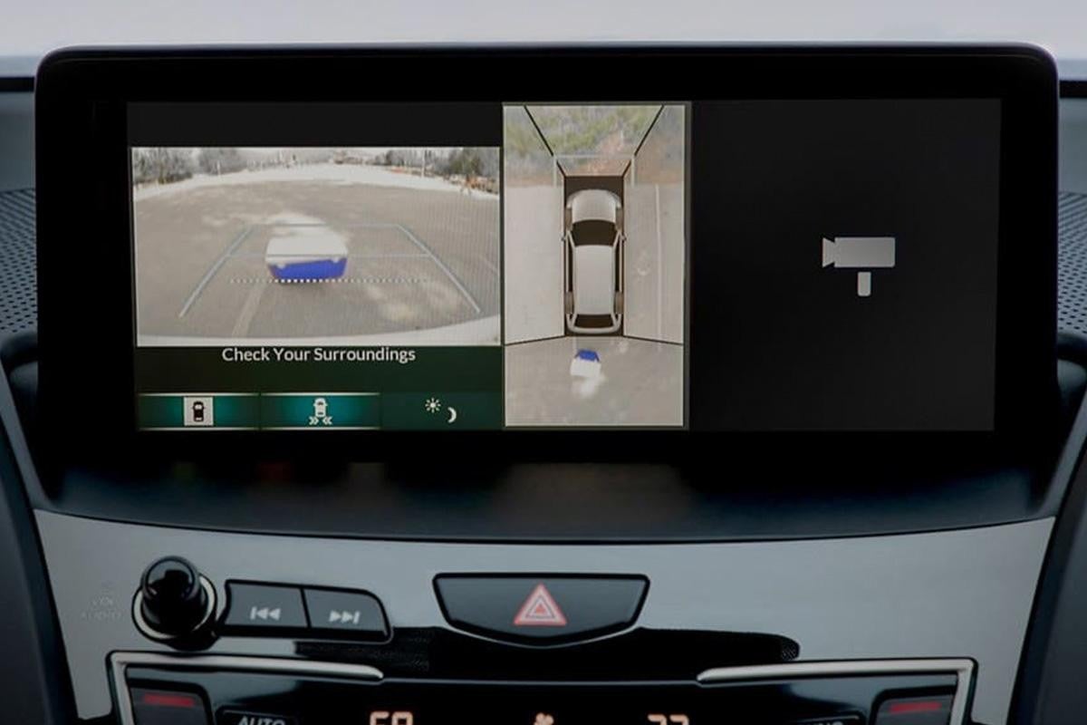 Car display showing rearview and 360-degree parking camera system