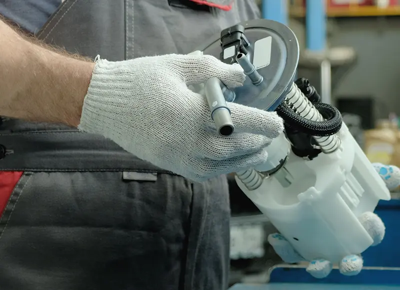Mechanic holding a car fuel pump module
