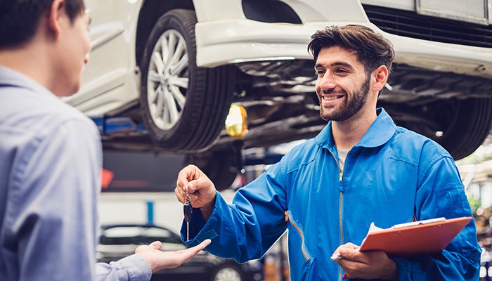 Salesman handing keys to a man.